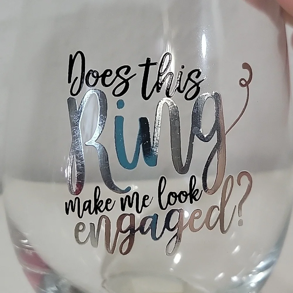 EUC stemless wine drinking glass that says does this ring make me look e…